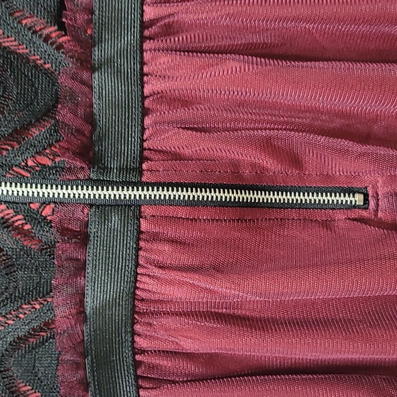 Burgundy dress with black design on the top art of the dress. Size Small - Picture 9 of 9